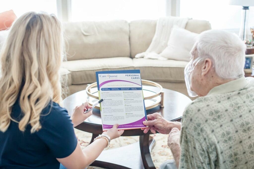 CareAparent employee reviewing care plan with older gentleman
